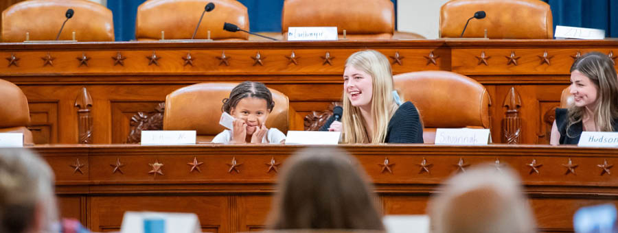 Two young girls sit in Congress.