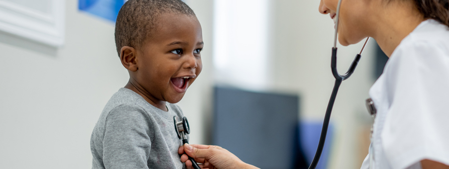 Happy child is examined by pediatrician.