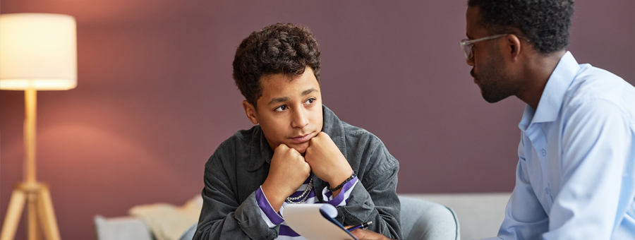 Teen talks with social worker.
