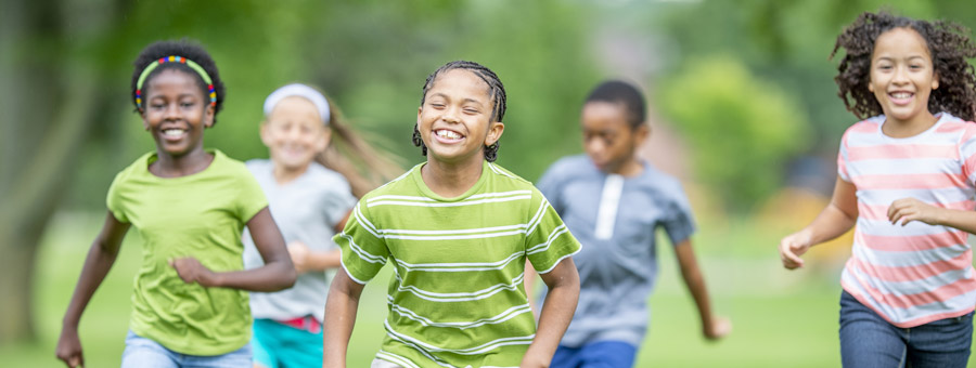 Happy kids running a race.