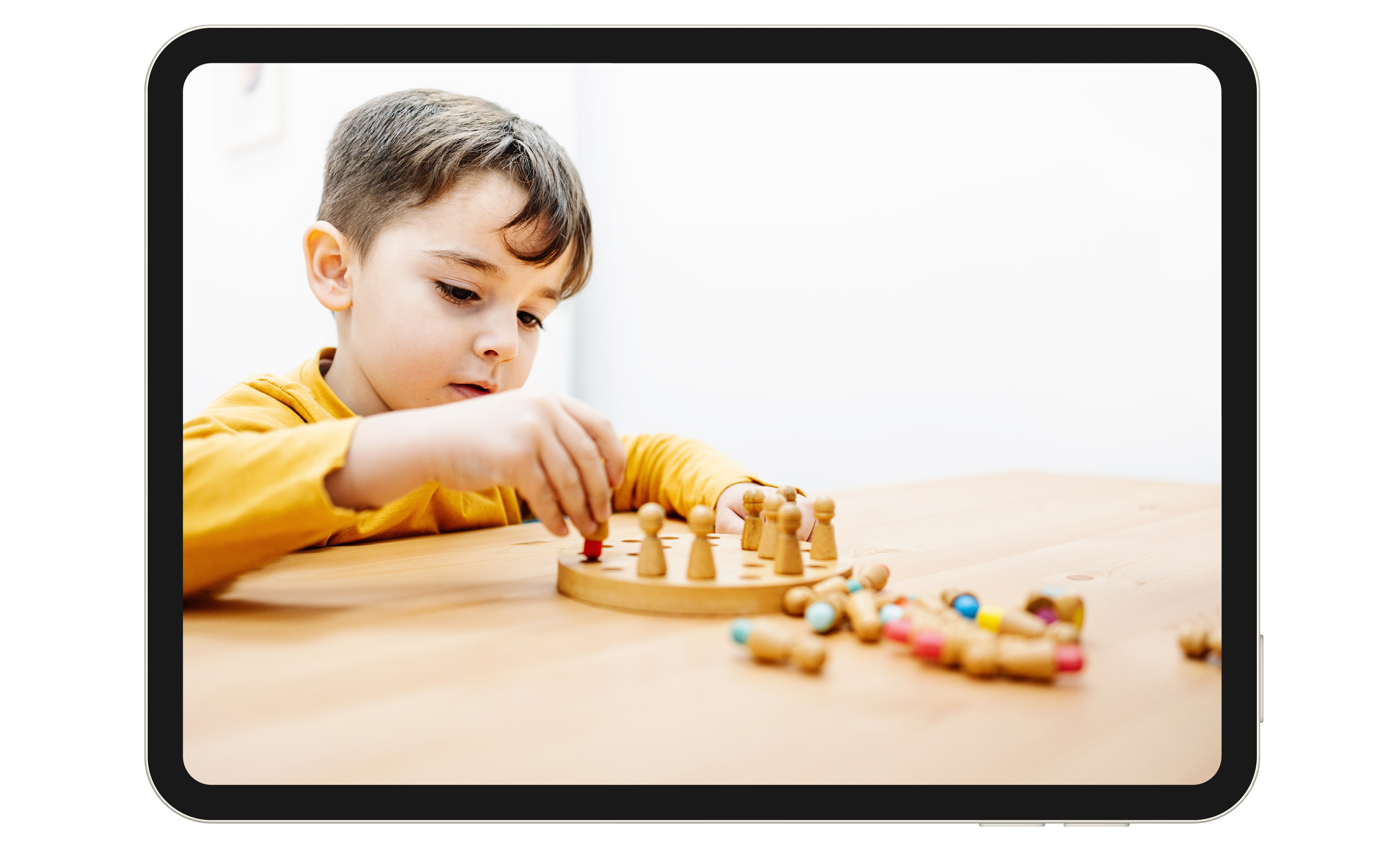 Child playing with toys at a table.