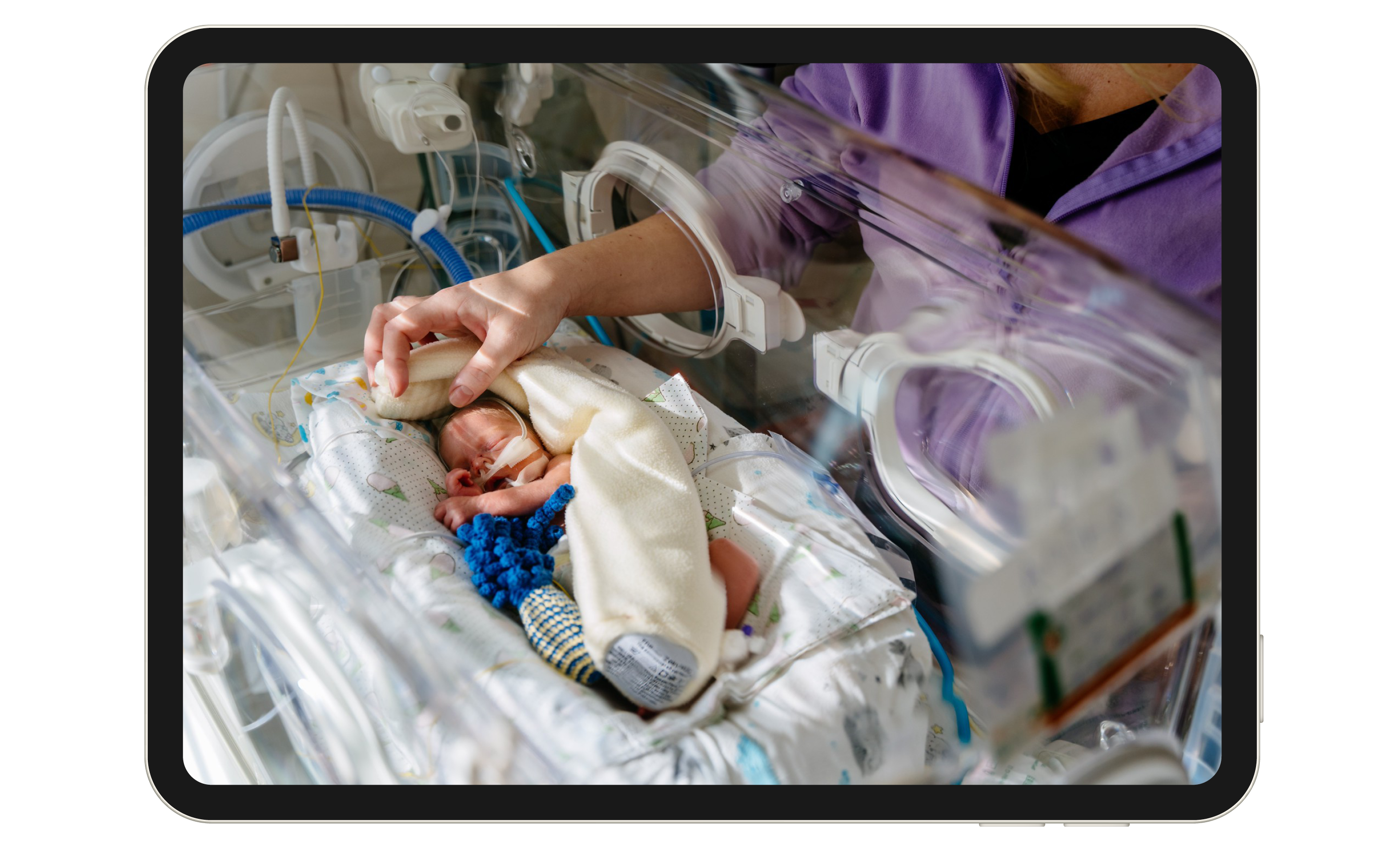 Nurse cares for baby in hospital nursery.