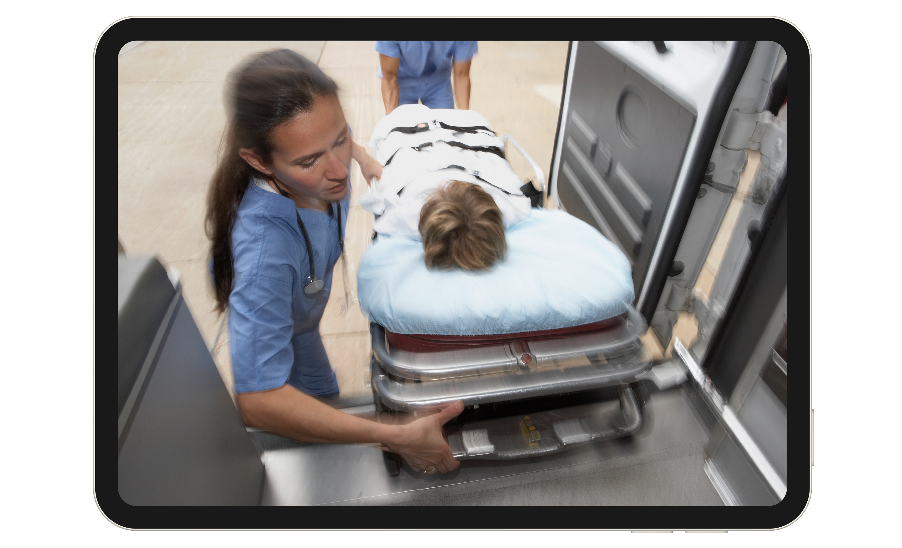 An EMT loads a child on a gurney into an ambulance.