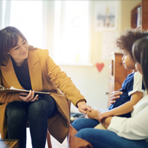 Therapist works with mother and child patient.